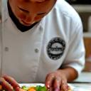 Chef preparing a dish with precision