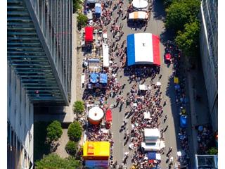 Crowded Toronto street festival visible from CN Tower in summer, vibrant and busy.