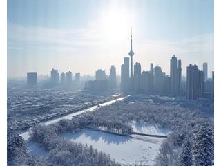 Snow-covered Toronto skyline from CN Tower, sparkling under winter sun.